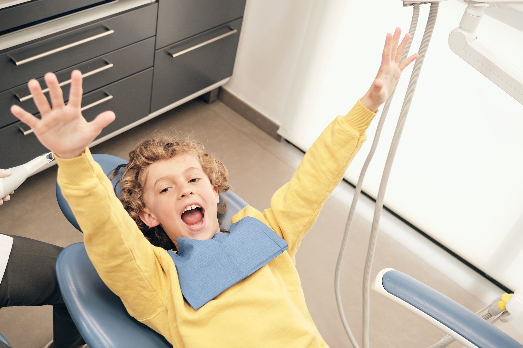 happy boy lying down in dental clinic