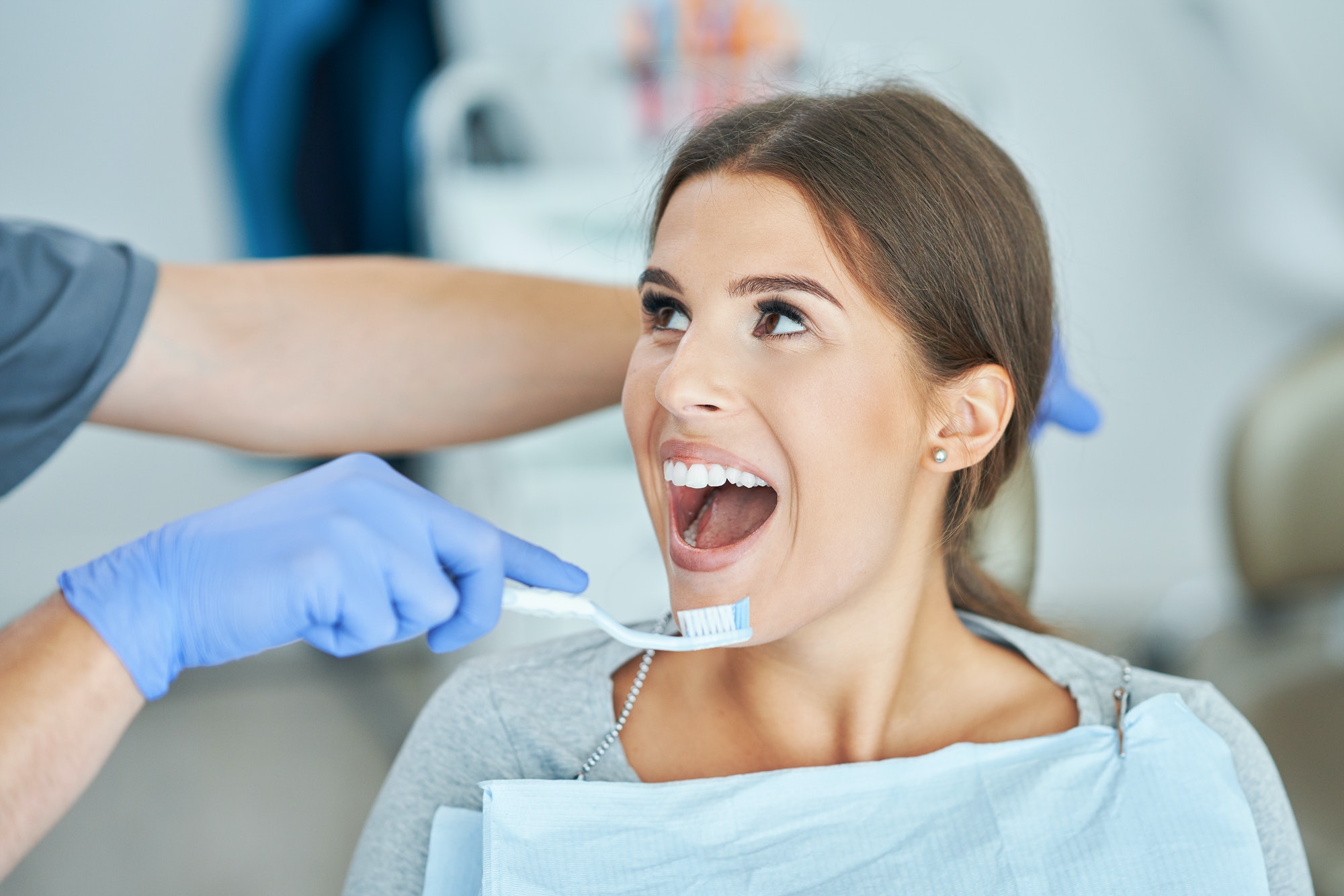 Male dentist and woman in dentist office