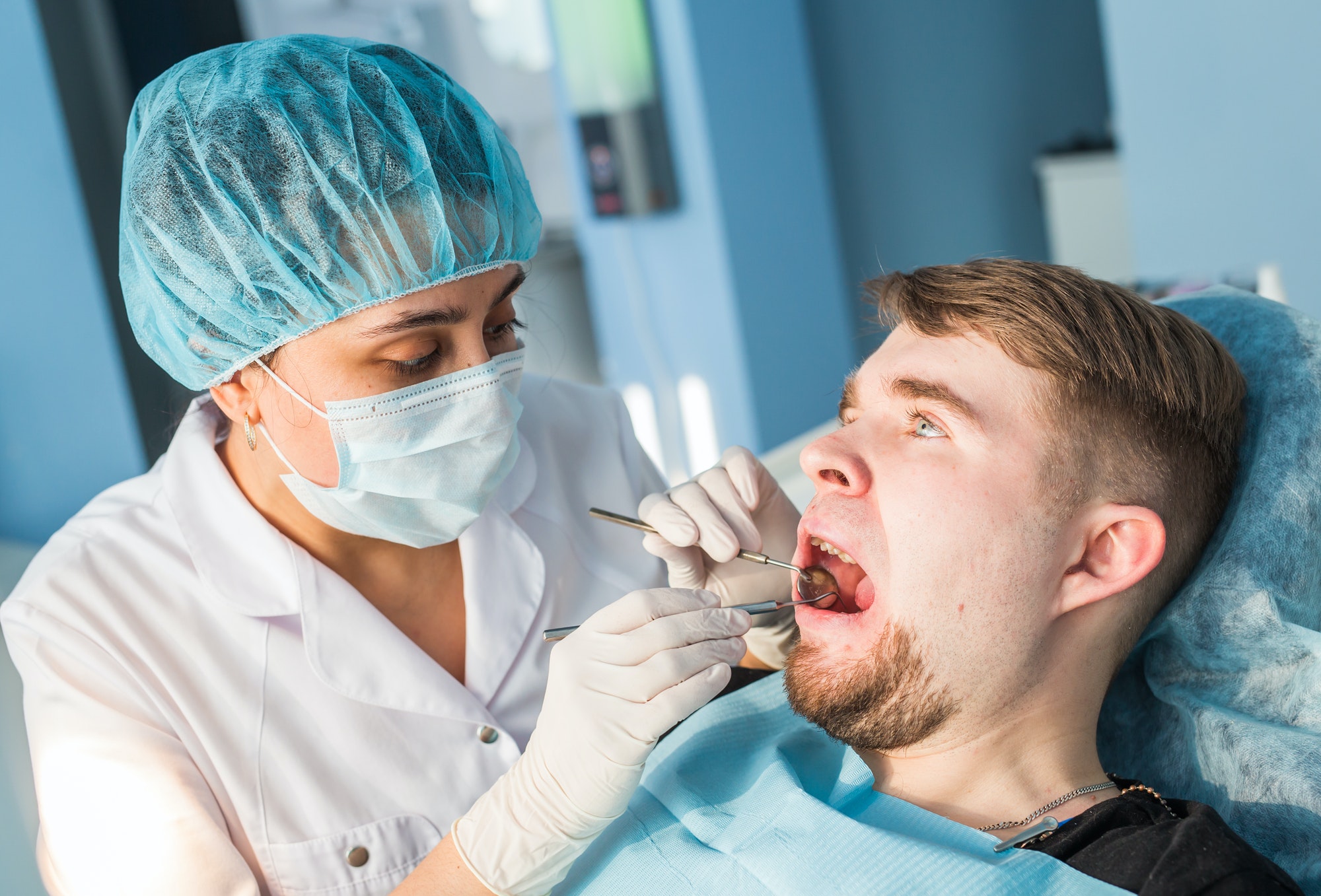 Overview of dental caries prevention. man at the dentist's chair during a dental procedure