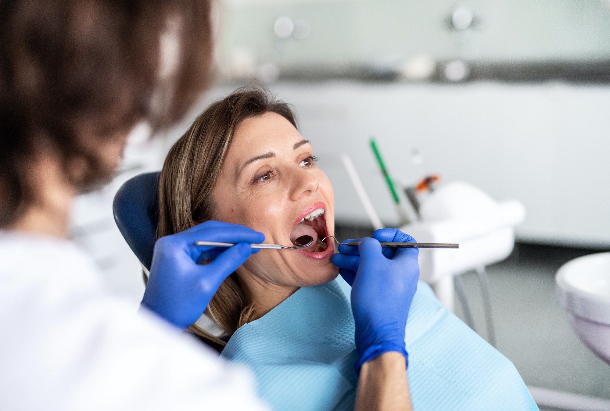A woman has a dental check-up in dentist surgery