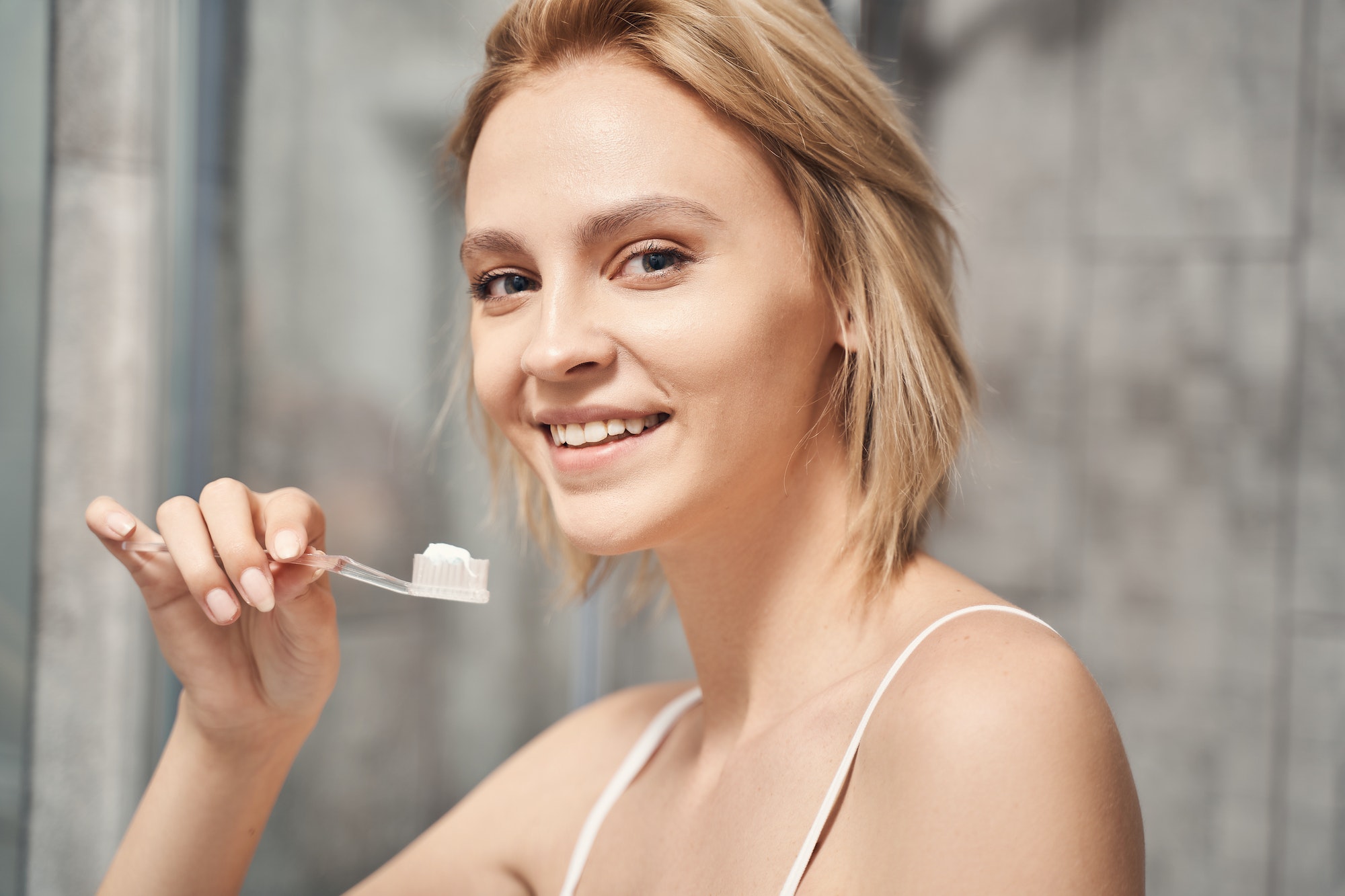 Joyous woman taking care of her oral health