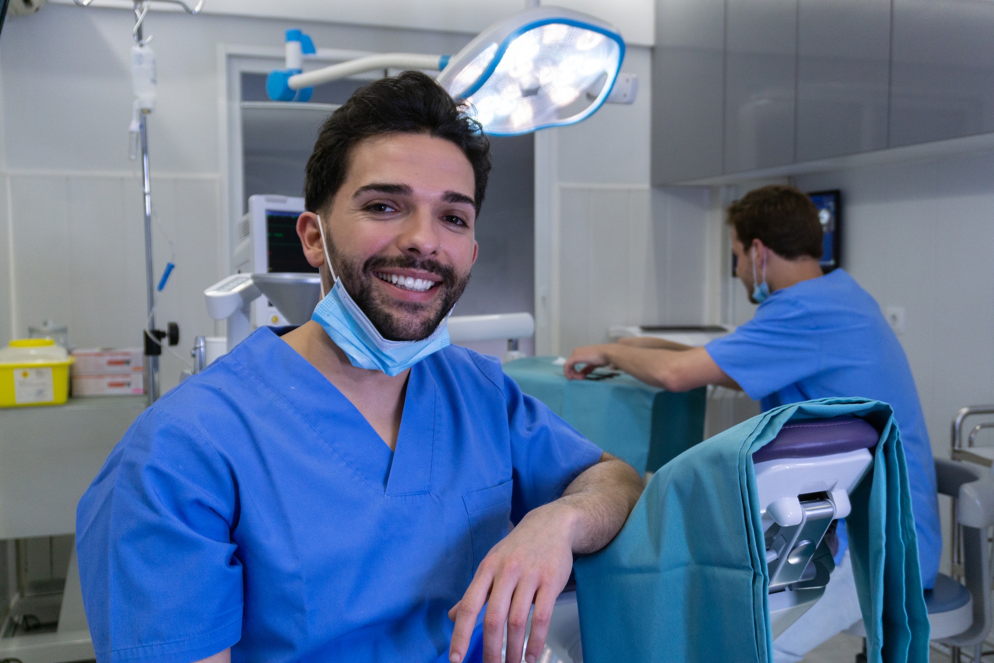 Young smiling dentist in the dental clinic before a surgery